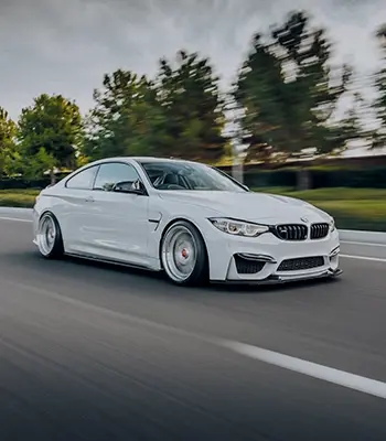 A white BMW on the road.